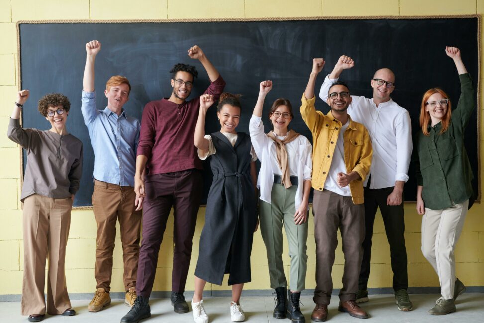 University students standing at the front of a class.